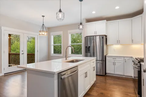 a kitchen with a refrigerator a sink and a stove