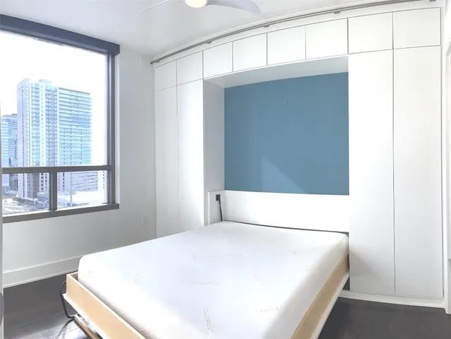 a bedroom with a bed and a window