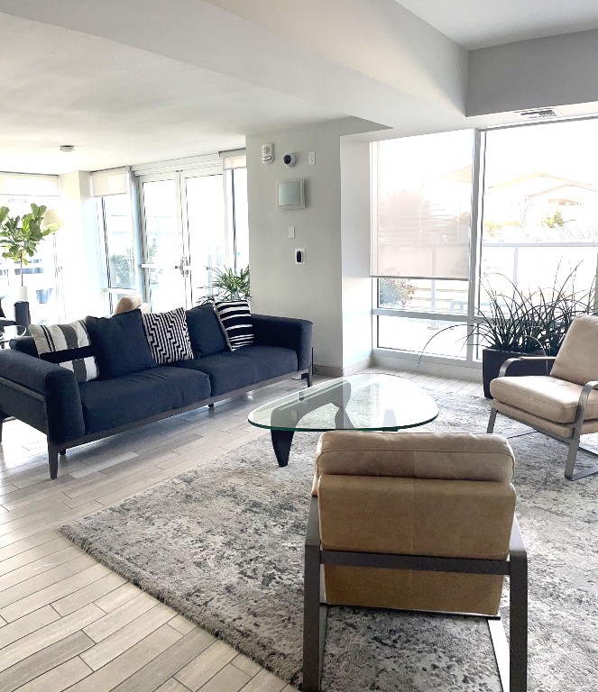 300 Bowie Street, Unit 1001 Austin, TX 78703 - Photo 16 of 18 a living room with furniture and a large window
