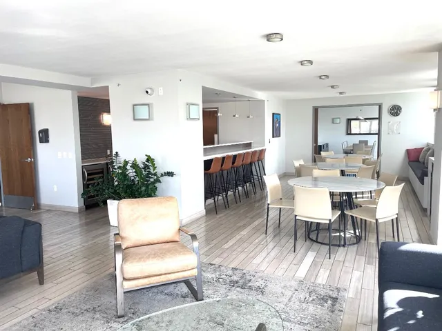 a living room with furniture a dining table and a flat screen tv