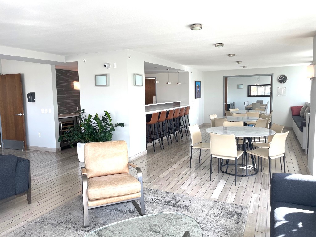 300 Bowie Street, Unit 1001 Austin, TX 78703 - Photo 17 of 18 a living room with furniture a dining table and a flat screen tv