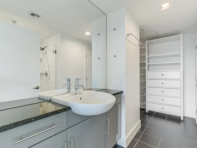 a bathroom with a sink a vanity and a mirror