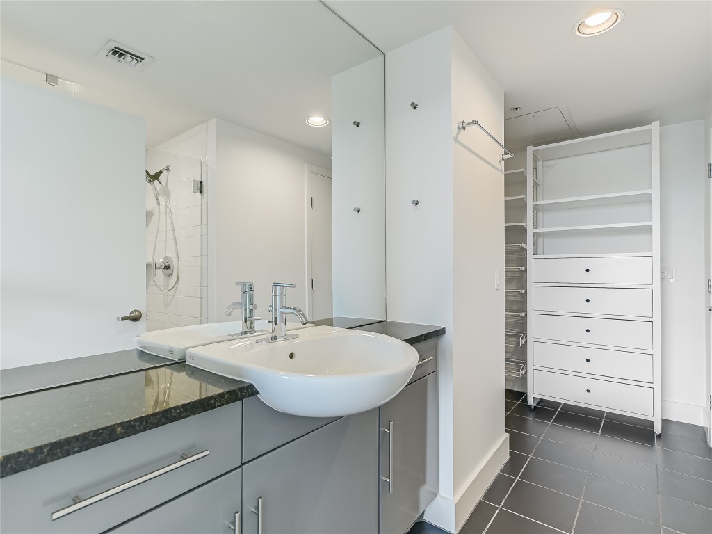 300 Bowie Street, Unit 1001 Austin, TX 78703 - Photo 9 of 18 a bathroom with a sink a vanity and a mirror