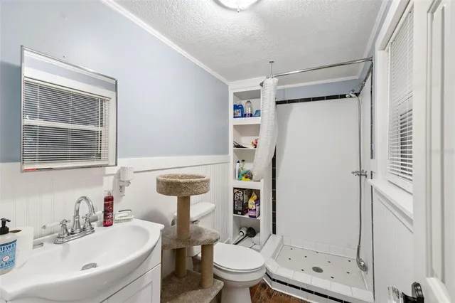 a bathroom with a sink toilet and shower