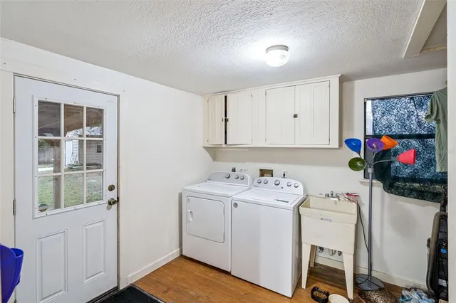 a utility room with cabinets washer and dryer