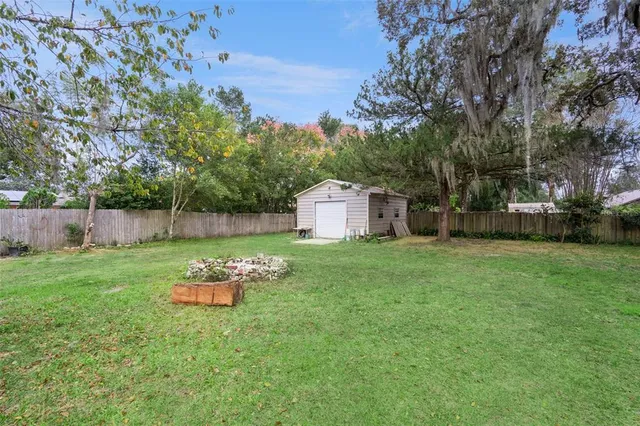 a backyard of a house with table and chairs