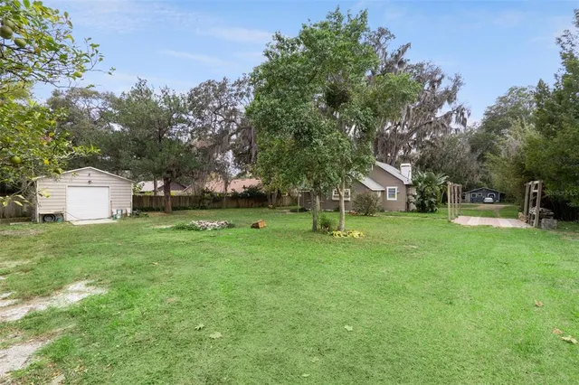 a backyard of a house with table and chairs