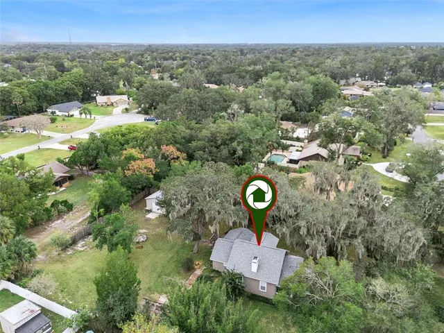 an aerial view of a house with a swimming pool