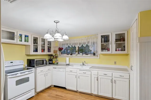 a kitchen with a stove a sink and a refrigerator