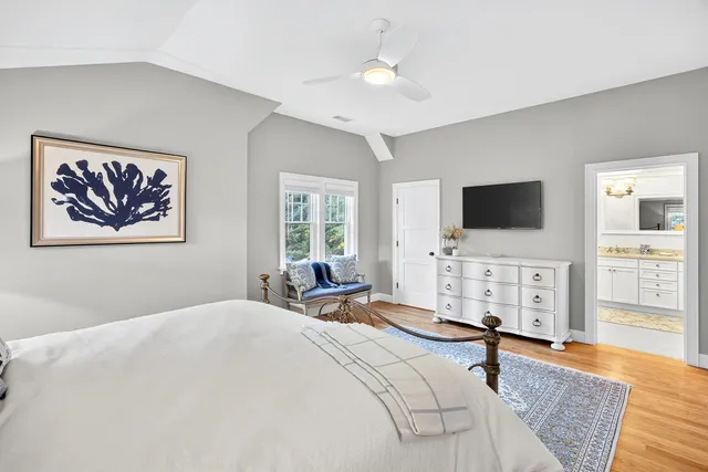 a bedroom with two beds and a large window