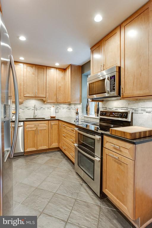 4914 29th Road South, Unit A2 Arlington, VA 22206 - Photo 2 of 30 a kitchen with stainless steel appliances granite countertop a stove a sink and a refrigerator