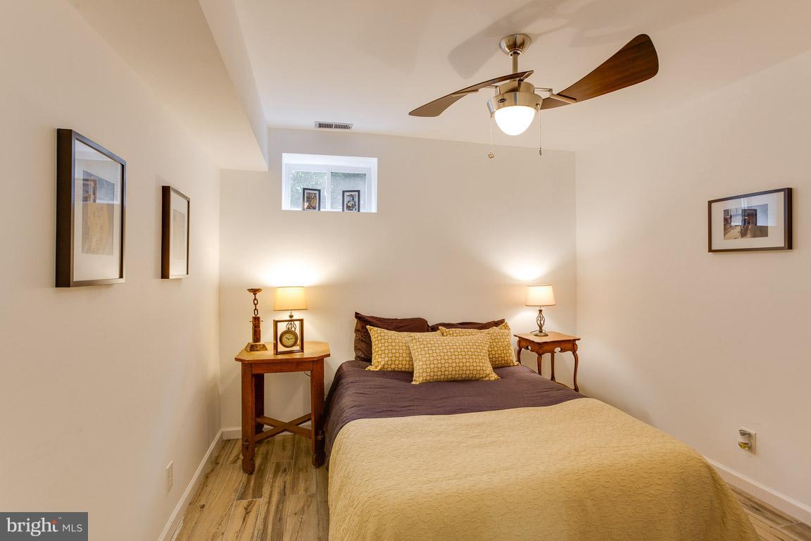 4914 29th Road South, Unit A2 Arlington, VA 22206 - Photo 20 of 30 a bedroom with a bed and a chandelier