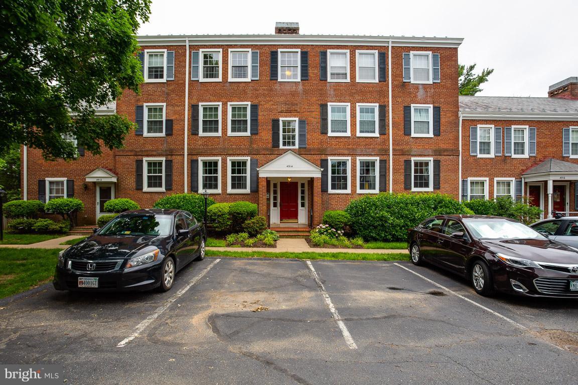 4914 29th Road South, Unit A2 Arlington, VA 22206 - Photo 27 of 30 a car parked in front of a brick house with a yard