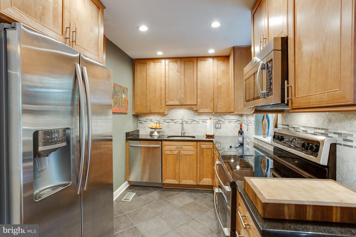 4914 29th Road South, Unit A2 Arlington, VA 22206 - Photo 3 of 30 a kitchen with stainless steel appliances granite countertop a refrigerator a stove and a sink