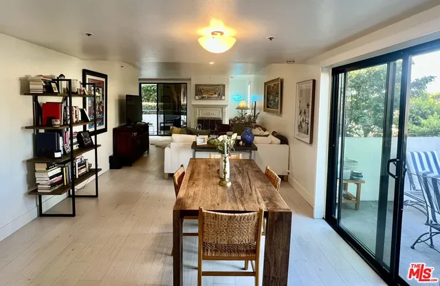 a living room with furniture a window and a flat screen tv