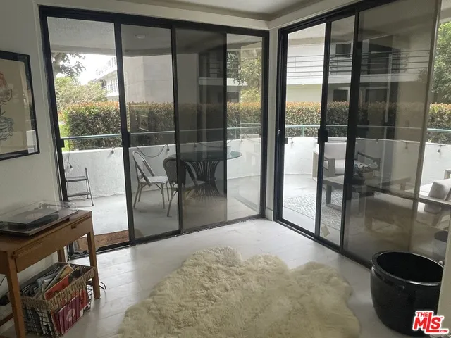 a roof deck with couches and a potted plant