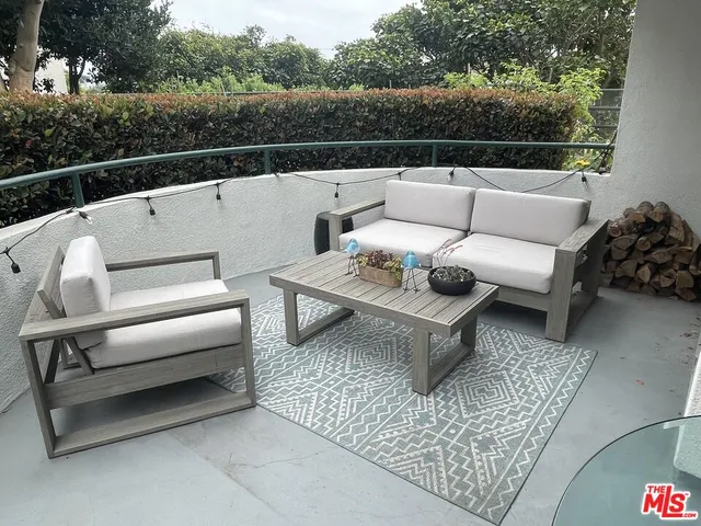 a terrace with outdoor seating and city view