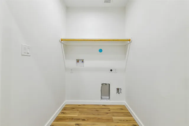 a view of a livingroom with a ceiling fan & wooden floor