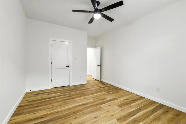 a view of a room with a window and wooden floor