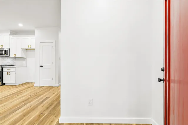 a kitchen with stainless steel appliances granite countertop white cabinets granite counter tops and a window