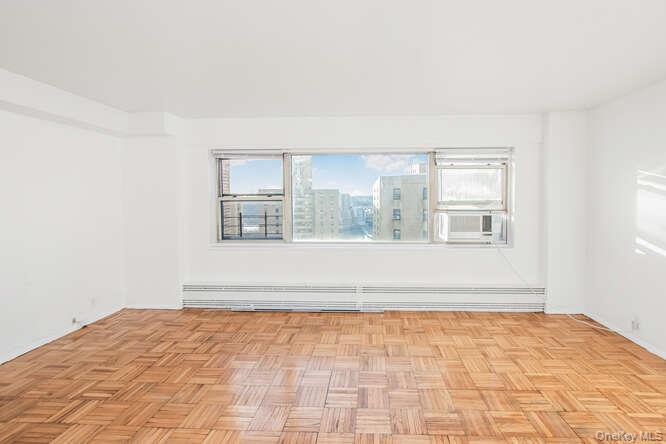 6 Fordham Hill Ovl, Unit 15F Bronx, NY 10468 - Photo 4 of 26 Entry to living room with view to the city
