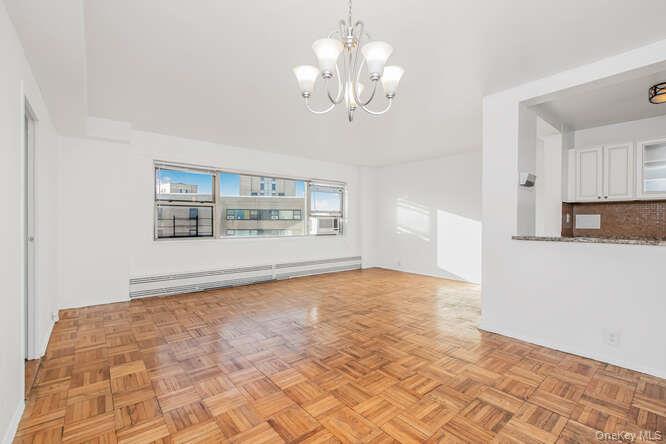 6 Fordham Hill Ovl, Unit 15F Bronx, NY 10468 - Photo 5 of 26 Living room and view to galley kitchen
