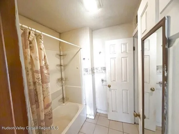a bathroom with a tub and shower