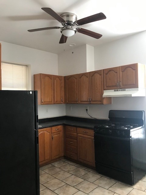 178 Orient Street, Unit 2 Bayonne, NJ 07002 - Photo 1 of 1 a kitchen with a sink a refrigerator and cabinets
