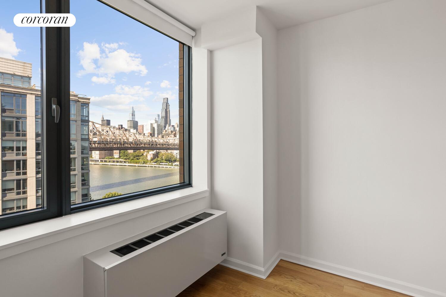 425 Main Street, Unit 15E Manhattan, NY 10044 - Photo 25 of 30 a view of a room with wooden floor and a window