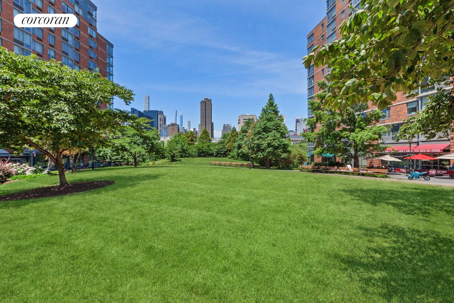 425 Main Street, Unit 15E Manhattan, NY 10044 - Photo 29 of 30 a view of a garden with a building in the background