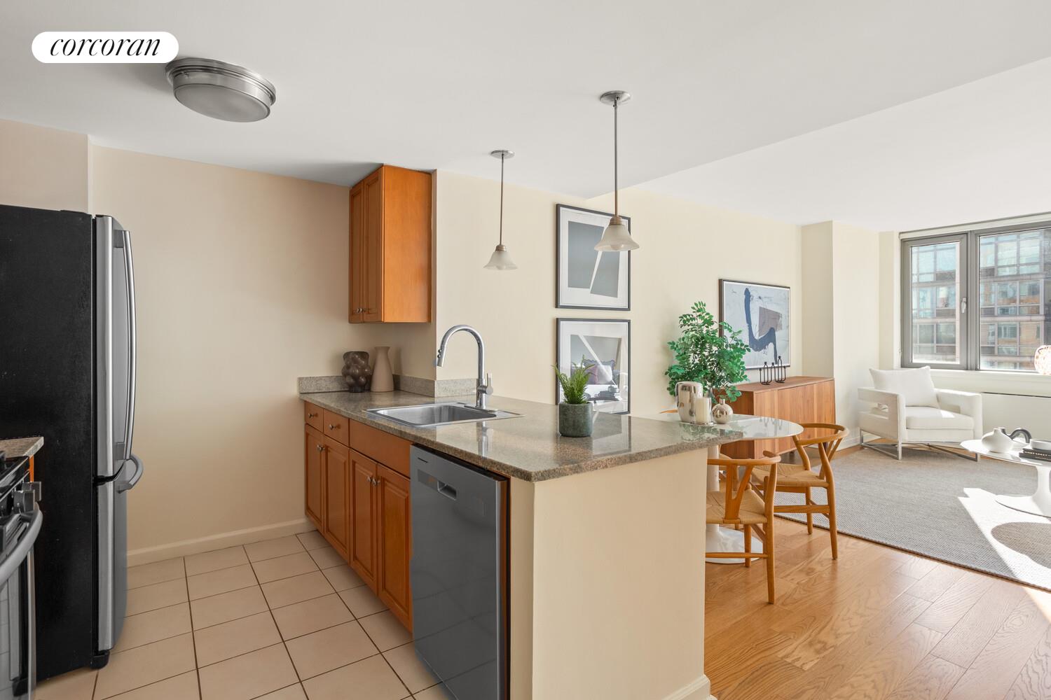 425 Main Street, Unit 15E Manhattan, NY 10044 - Photo 2 of 30 a kitchen with stainless steel appliances granite countertop a sink a stove and a refrigerator