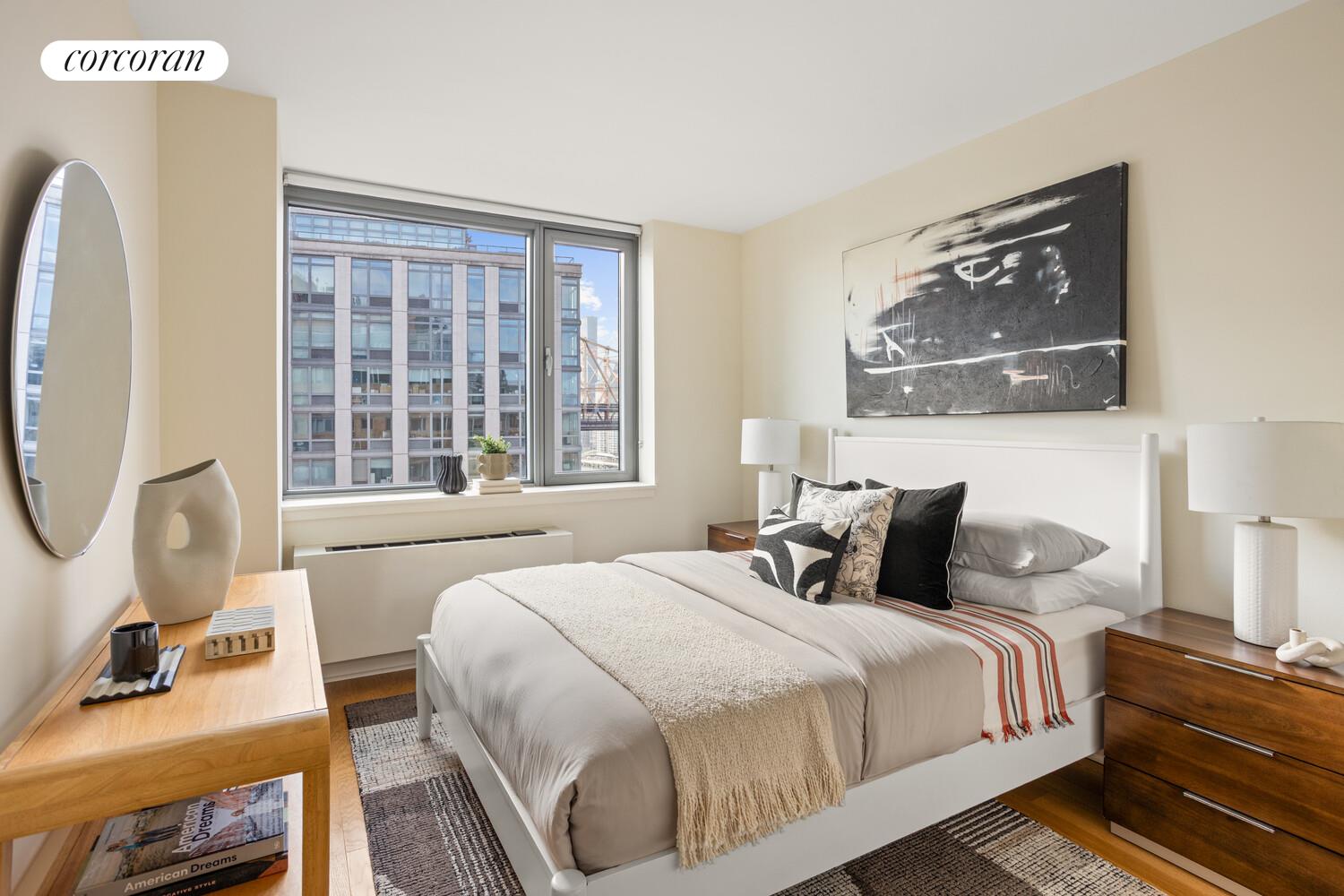 425 Main Street, Unit 15E Manhattan, NY 10044 - Photo 3 of 30 a bedroom with bed and a large window