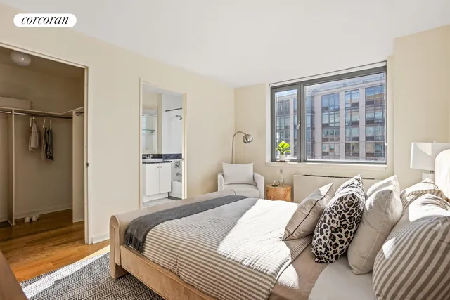 a bedroom with bed and a large window