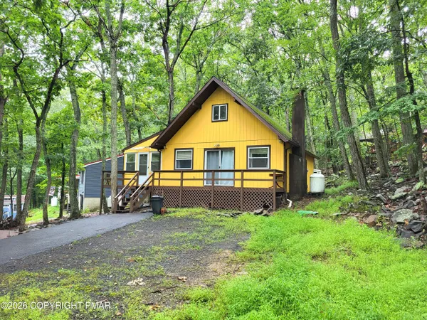 a front view of house with yard and green space