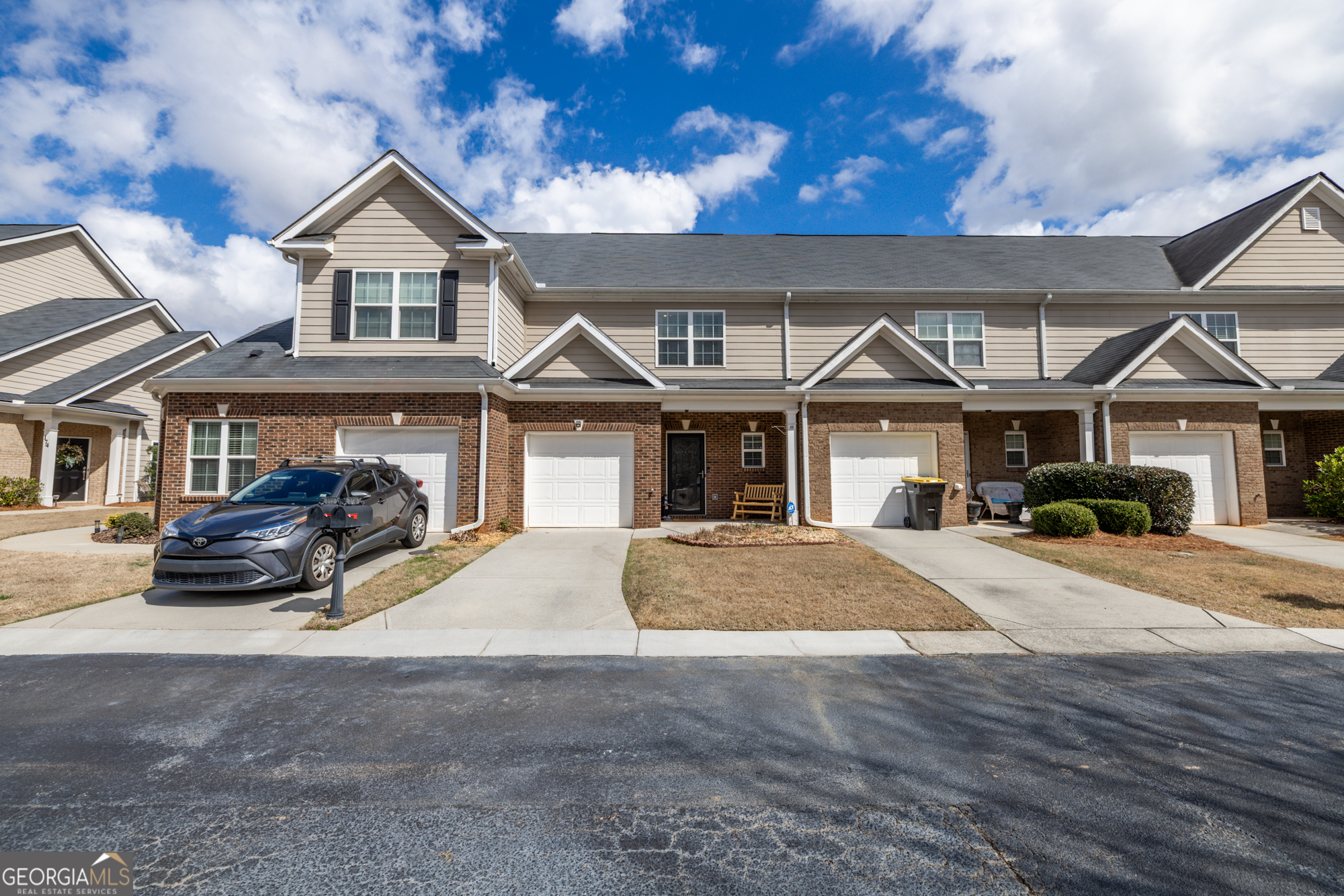 a front view of a house with yard porch and parking