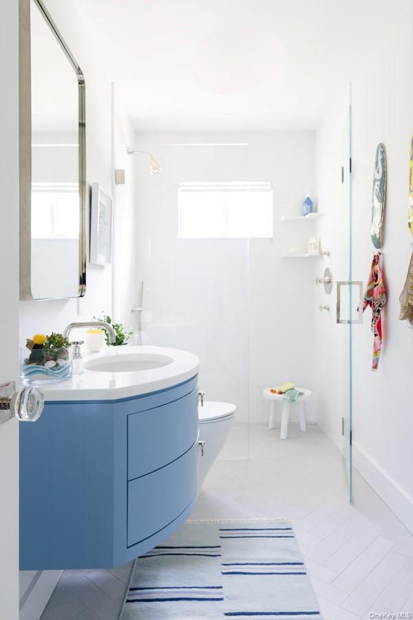 48 Middle Pond Road Southampton, NY 11968 - Photo 21 of 22 a bathroom with a sink a toilet and a mirror
