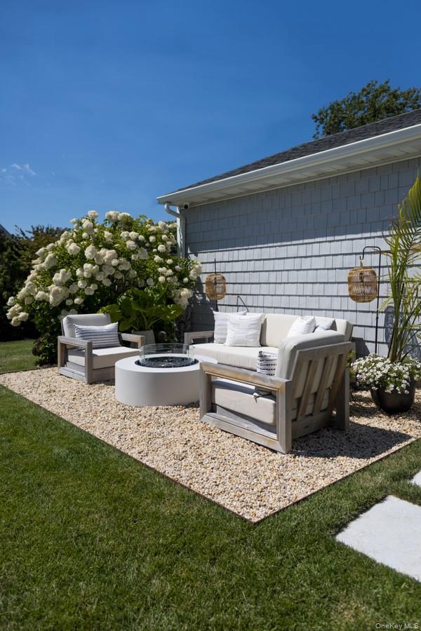 48 Middle Pond Road Southampton, NY 11968 - Photo 3 of 22 a view of a patio with table and chairs with a yard