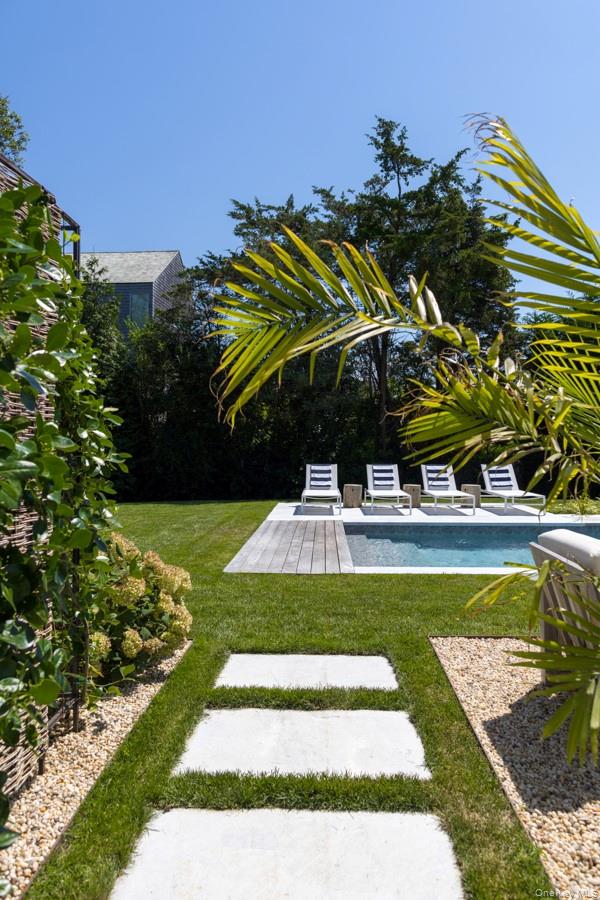 48 Middle Pond Road Southampton, NY 11968 - Photo 4 of 22 a view of a swimming pool with a garden