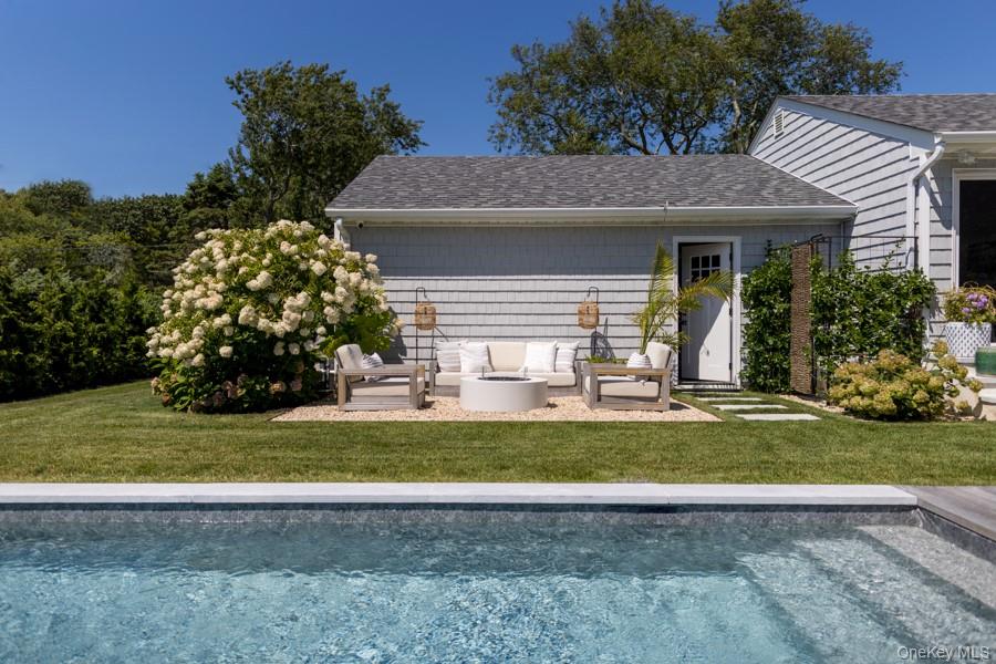 48 Middle Pond Road Southampton, NY 11968 - Photo 6 of 22 a front view of a house with a yard and garage