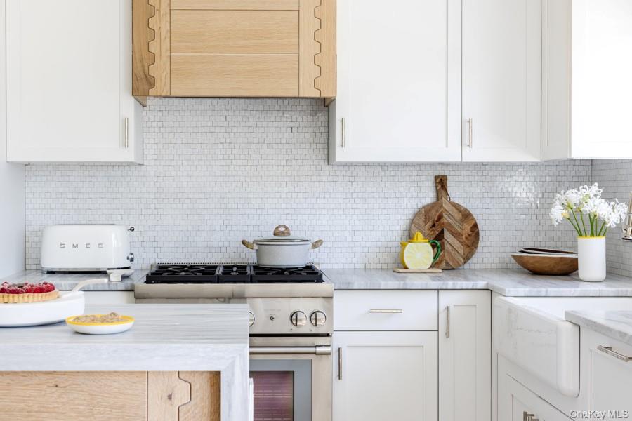 48 Middle Pond Road Southampton, NY 11968 - Photo 8 of 22 a kitchen with a stove and a white wooden cabinets