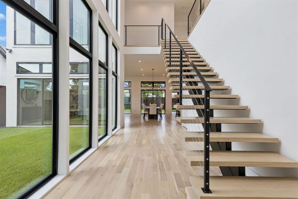 3949 Rochelle Drive Dallas, TX 75220 - Photo 2 of 37 Dramatic foyer with floating stairs and wall of windows