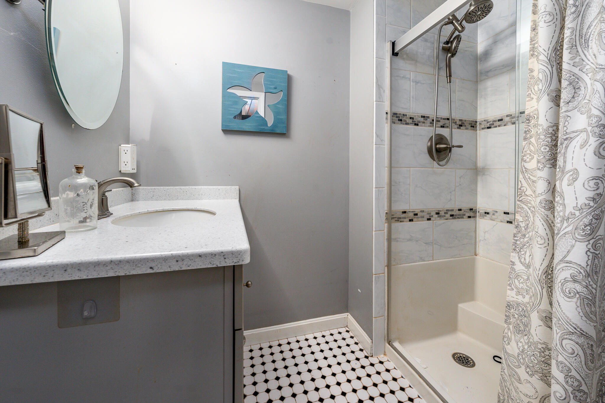 34 Erics Way, Unit G 7 Wellfleet, MA 02667 - Photo 10 of 24 a bathroom with a granite countertop sink a mirror a vanity and shower