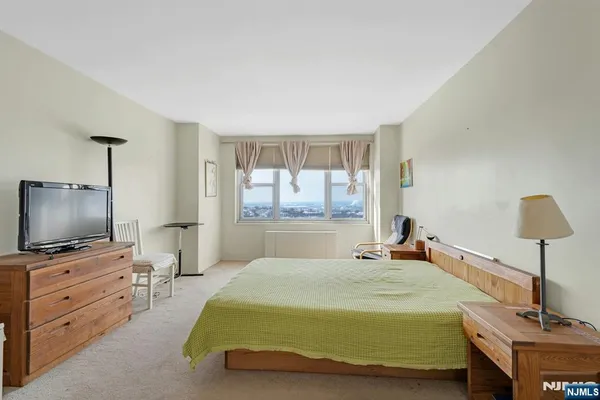 a bedroom with a bed and chair
