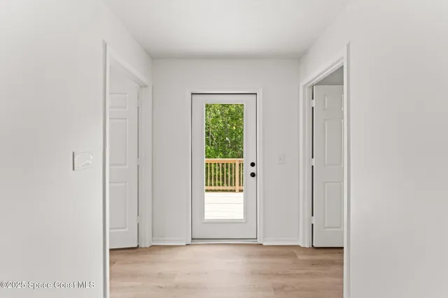 a balcony with wooden floor and fence