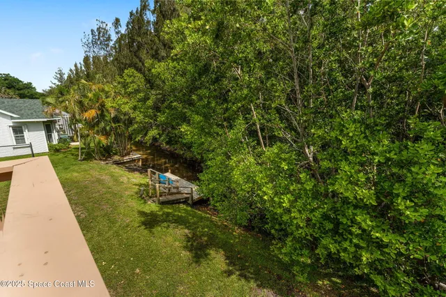 an empty room with wooden floor and window