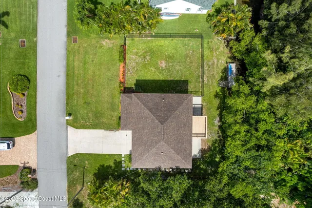 a backyard of a house with a yard and outdoor seating