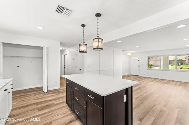 a large kitchen with stainless steel appliances granite countertop plenty wooden cabinets counter space a sink and a window