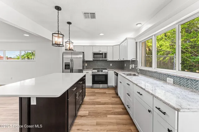a view of a kitchen cabinets and wooden floor