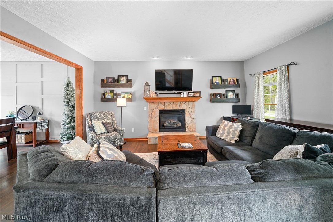 4849 Edson Road Kent, OH 44240 - Photo 12 of 50 Living room with a stone fireplace and hardwood / wood-style flooring