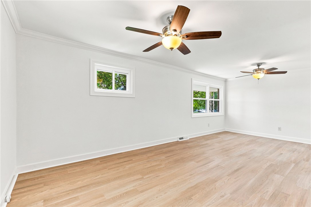 205 Timms Road Piedmont, SC 29673 - Photo 14 of 36 Polished flooring and classic crown molding anchor this versatile, light-filled interior space.